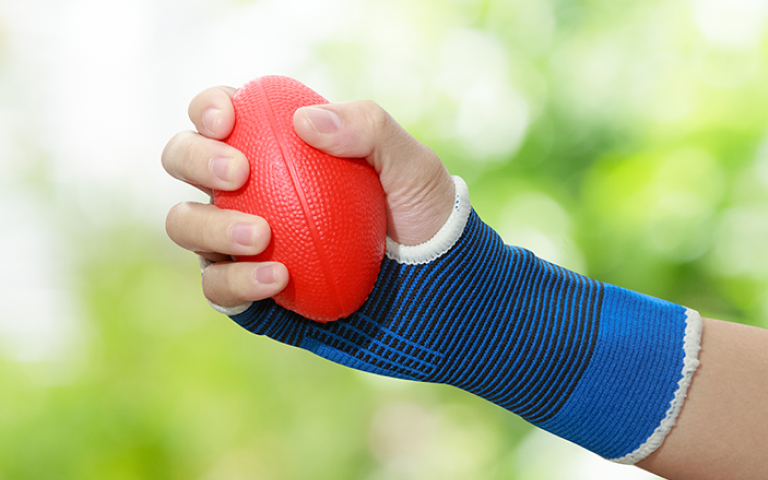 Image of the hand of a person using a squeeze ball