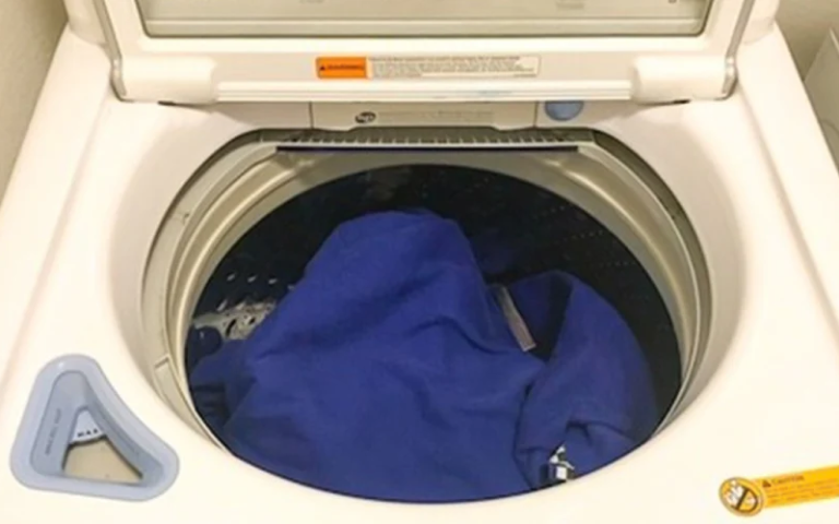 Photo of a BJJ gi inside a laundry machine